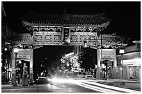Chinatown gate with trail of lights at night. Victoria, British Columbia, Canada (black and white)