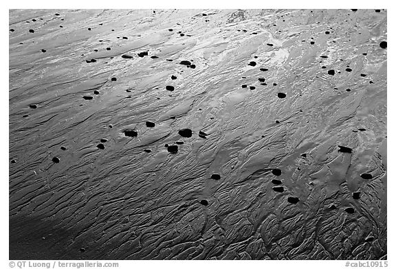 Pebbles and wet sand at sunset, Half-moon bay. Pacific Rim National Park, Vancouver Island, British Columbia, Canada (black and white)