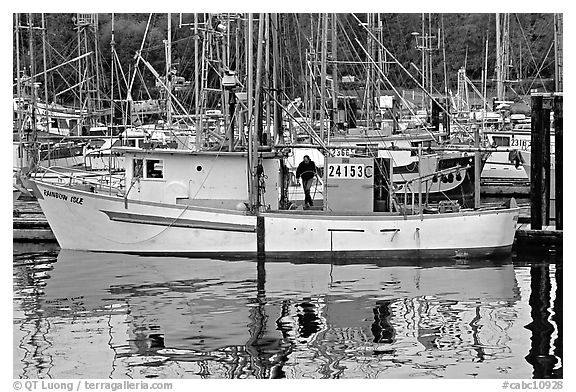 Fishing boat and reflections in harbor, Uclulet. Vancouver Island, British Columbia, Canada (black and white)