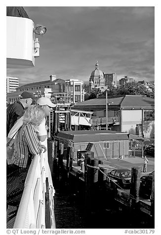 Passengers standing on the deck of the ferry, as it sails into the Inner Harbor. Victoria, British Columbia, Canada (black and white)