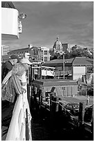 Passengers standing on the deck of the ferry, as it sails into the Inner Harbor. Victoria, British Columbia, Canada ( black and white)