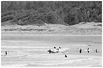 Surfers in Long Beach, the best surfing spot on Canada's west coast. Pacific Rim National Park, Vancouver Island, British Columbia, Canada (black and white)