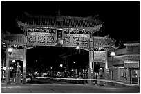 Gate of Harmonious Interest marking the entrance of Chinatown, night. Victoria, British Columbia, Canada (black and white)