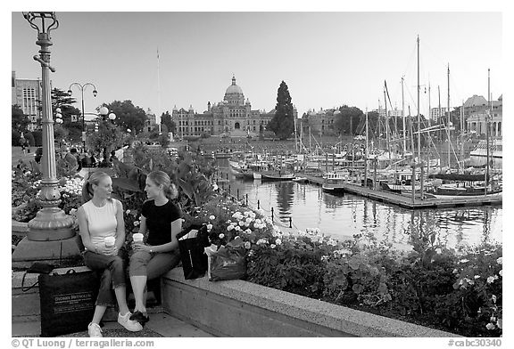 Young Women sitting, Inner harbor. Victoria, British Columbia, Canada (black and white)