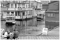 Harbor ferries and outdoor eatery, Upper Harbor. Victoria, British Columbia, Canada ( black and white)