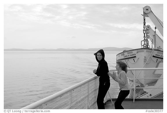 Woman and girl looking out from deck of ferry. Vancouver Island, British Columbia, Canada