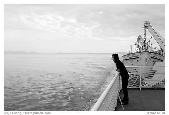 Woman looking out from deck of ferry. Vancouver Island, British Columbia, Canada (black and white)