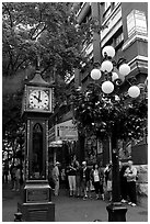 Tourists watch steam clock in Water Street. Vancouver, British Columbia, Canada ( black and white)