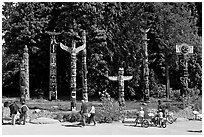 Tourists loooking at Totems, Stanley Park. Vancouver, British Columbia, Canada (black and white)