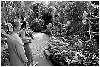 Women listening to the white parrot, Bloedel conservatory, Queen Elizabeth Park. Vancouver, British Columbia, Canada (black and white)