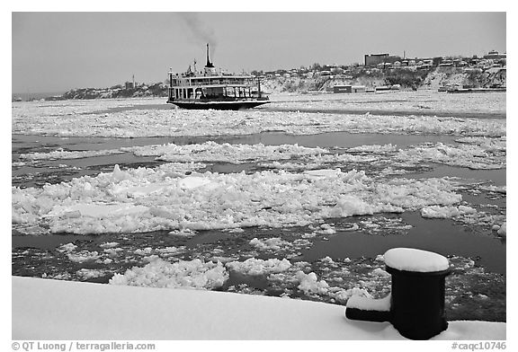 Ferry crossing the Saint Laurent river partly covered with ice, Quebec City. Quebec, Canada (black and white)