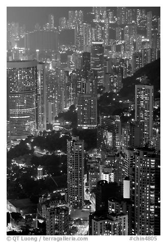 Residential towers on steep hillside from Victoria Peak by night. Hong-Kong, China (black and white)
