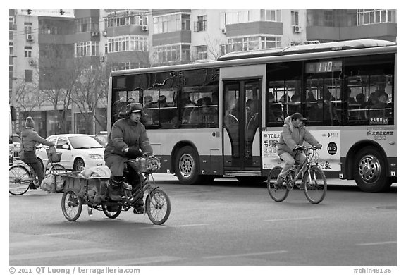Tricyle, bicycles and bus on street. Beijing, China