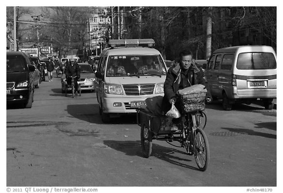 Tricycle and taxi on street. Beijing, China