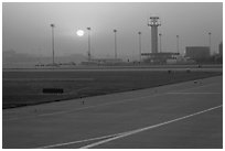 Tarmac and control tower at sunset, Beijing Capital International Airport. Beijing, China ( black and white)