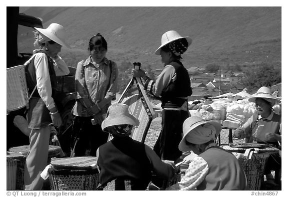 Bai women wearing tribespeople dress at the Monday market. Shaping, Yunnan, China (black and white)