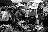 Bai women buying vegetables at the Monday market. Shaping, Yunnan, China (black and white)