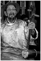 Elderly musician playing the traditional two-stringed Ehru. Baisha, Yunnan, China (black and white)