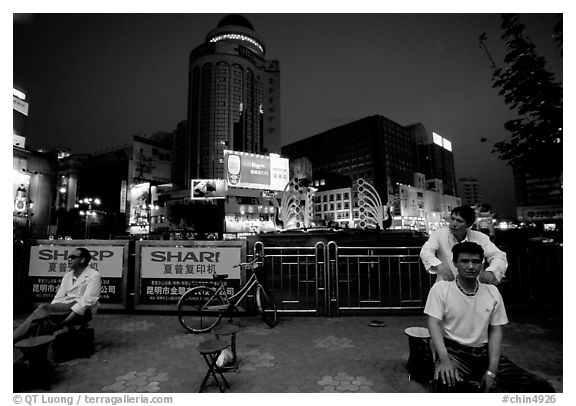 Public massage on the traffic square at  the intersection of Zhengyi Lu and Dongfeng Lu. Kunming, Yunnan, China (black and white)