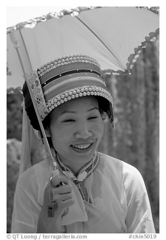 Woman from the Sani branch of the Yi tribespeople with a sun unbrella. Shilin, Yunnan, China