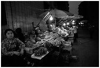 Fruit vendor, night market. Leshan, Sichuan, China ( black and white)