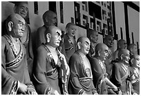A variety of postures and expressions of some of the 1000 Terracotta arhat monks in Luohan Hall. Leshan, Sichuan, China ( black and white)