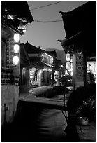 Streets, bridge, wooden houses, red lanterns and canal. Lijiang, Yunnan, China ( black and white)