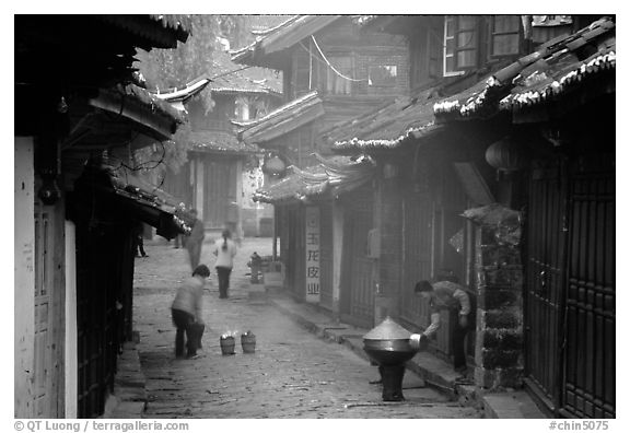 Street in the morning with dumplings being cooked. Lijiang, Yunnan, China