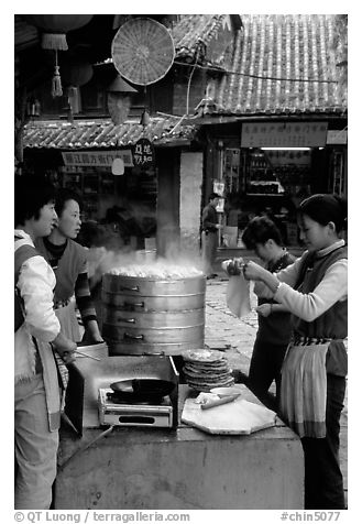 Naxi women selling dumplings and Naxi baba flatbread. Lijiang, Yunnan, China