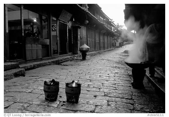 Dumplings being cooked in a cobblestone street. Lijiang, Yunnan, China