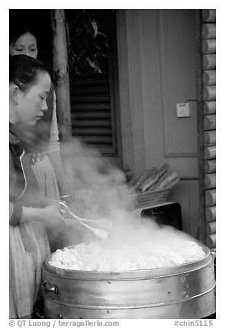Naxi Women baking dumplings. Lijiang, Yunnan, China