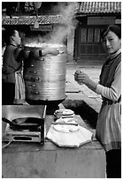 Naxi Woman preparing the baba flatbreat. Lijiang, Yunnan, China ( black and white)