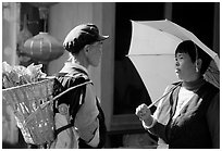 Two women conversing in the street. Lijiang, Yunnan, China ( black and white)