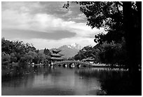 Pavillon reflected in the Black Dragon Pool, with Jade Dragon Snow Mountains in the background. Lijiang, Yunnan, China ( black and white)