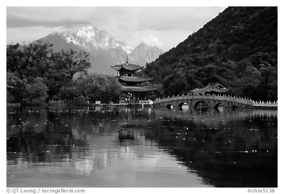 Pavillon and Jade Dragon Snow Mountains reflected in the Black Dragon Pool. Lijiang, Yunnan, China