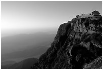 Jinding Si temple perched on a precipituous cliff at sunrise. Emei Shan, Sichuan, China ( black and white)