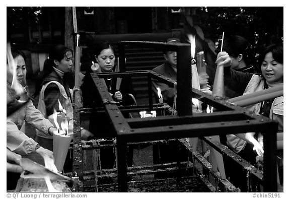 Pilgrims burning big incense batons. Emei Shan, Sichuan, China (black and white)