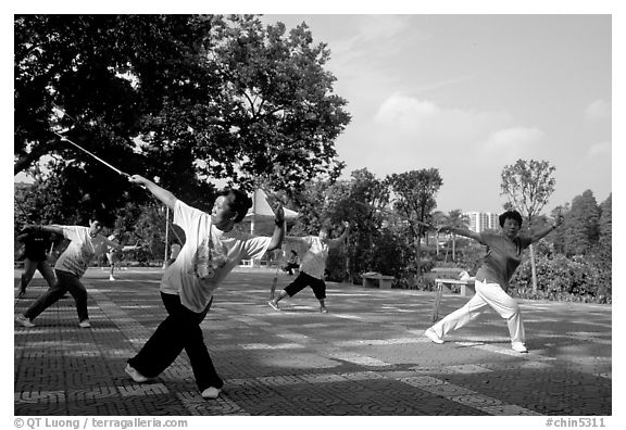 Collective exercise gymnastics with swords,  Liuha Park. Guangzhou, Guangdong, China (black and white)