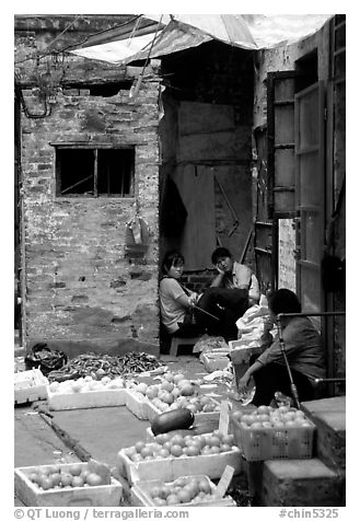 Fruit vendors in a narrow alley. Guangzhou, Guangdong, China (black and white)