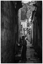 Man using stream water in alley. Hongcun Village, Anhui, China ( black and white)