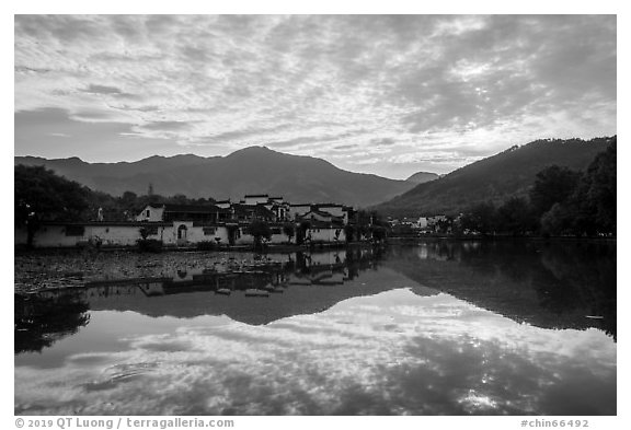 Village and clouds reflected in South Lake. Hongcun Village, Anhui, China (black and white)