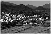 Field workers and village from above. Xidi Village, Anhui, China ( black and white)