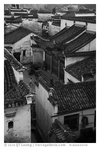 Zhuimu Tang from above with child at play. Xidi Village, Anhui, China (black and white)