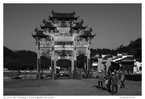 Villagers heading towrds fields, and Hu Wenguang Memorial Arch. Xidi Village, Anhui, China (black and white)