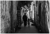 Father and daughter walking in alley. Xidi Village, Anhui, China ( black and white)