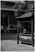 Woman at incense urn, Jingci Temple. Hangzhou, China ( black and white)