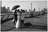 Bride and groom setting up for photos, the Bund. Shanghai, China ( black and white)