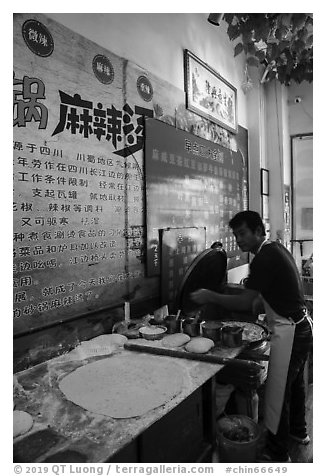 Man preparing breakfast pancakes. Shanghai, China (black and white)