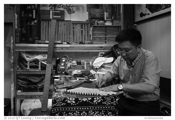 Man working on fan. Shanghai, China (black and white)