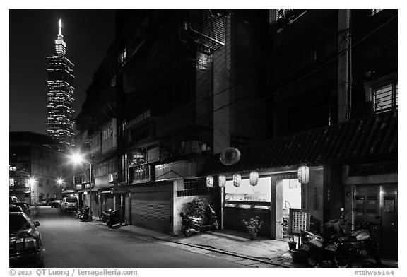 Dark street, store with lanters, and Taipei 101. Taipei, Taiwan (black and white)